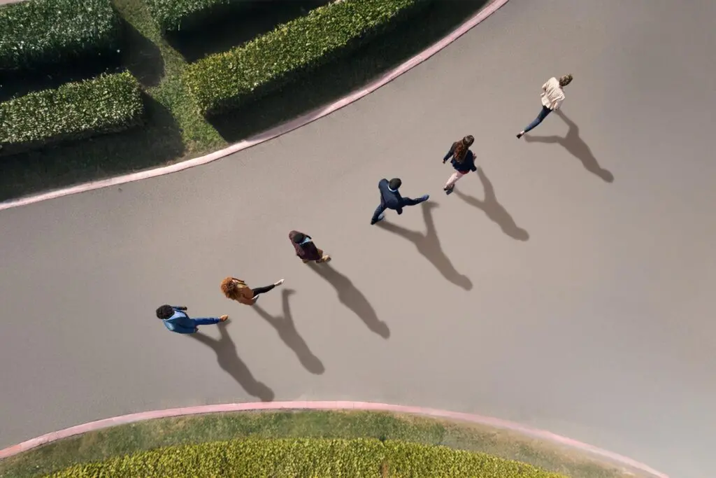 People walking in line towards success